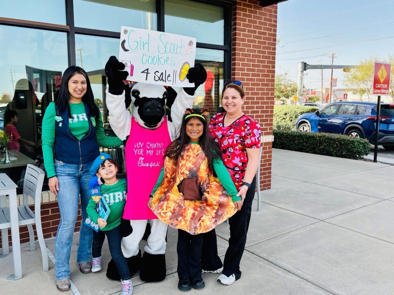 girl scout selling cookies with parent